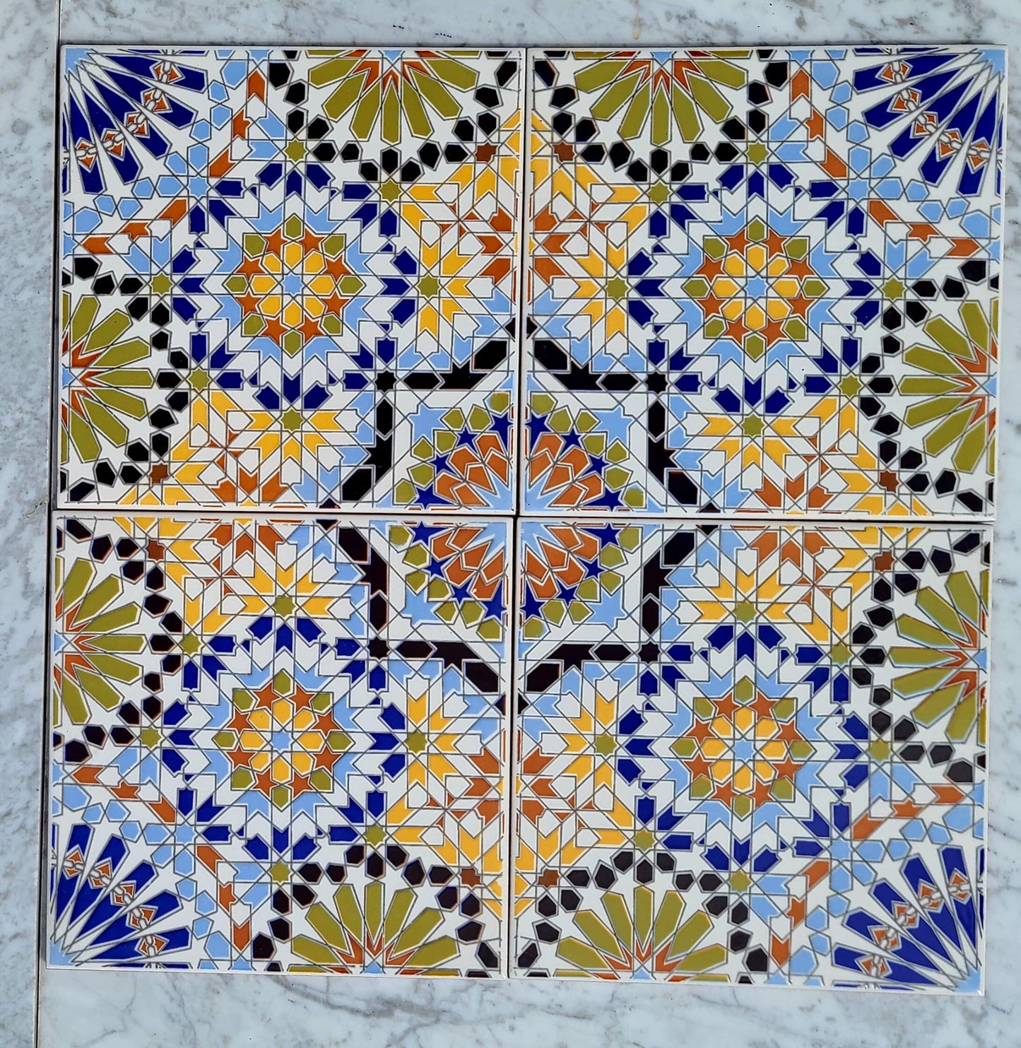 Colorful Moroccan tile by Justmorocco with intricate geometric patterns, showcasing vibrant blues and earthy tones.