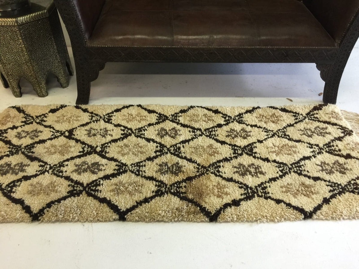 Beni ourain rug & Moroccan carved leather bench