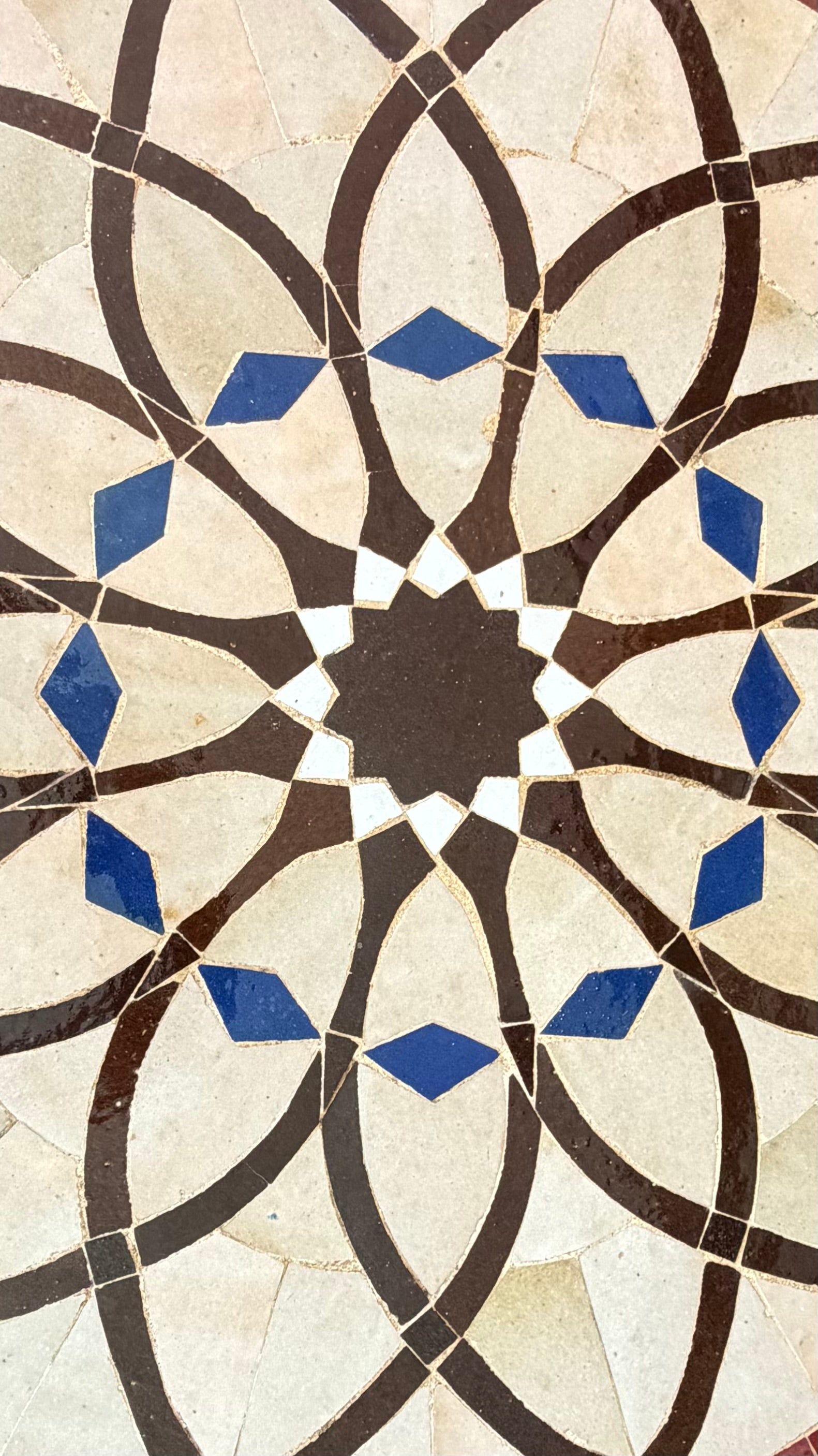 Moroccan Alhambra Palace tile by Justmorocco featuring intricate geometric blue and white patterns on ceramic surface.