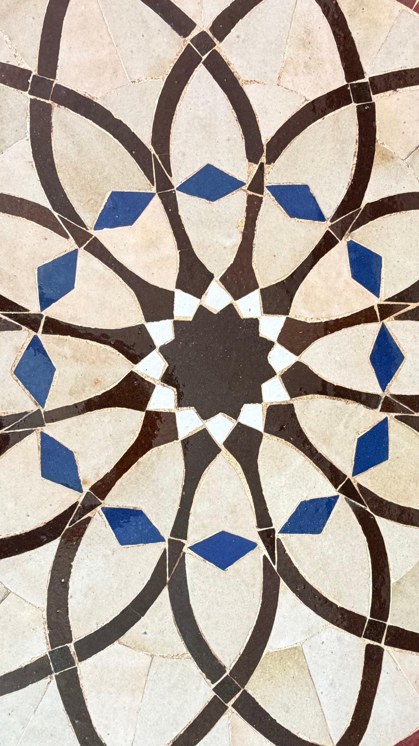 Moroccan Alhambra palace tile by Justmorocco featuring intricate blue and white geometric patterns in ceramic.