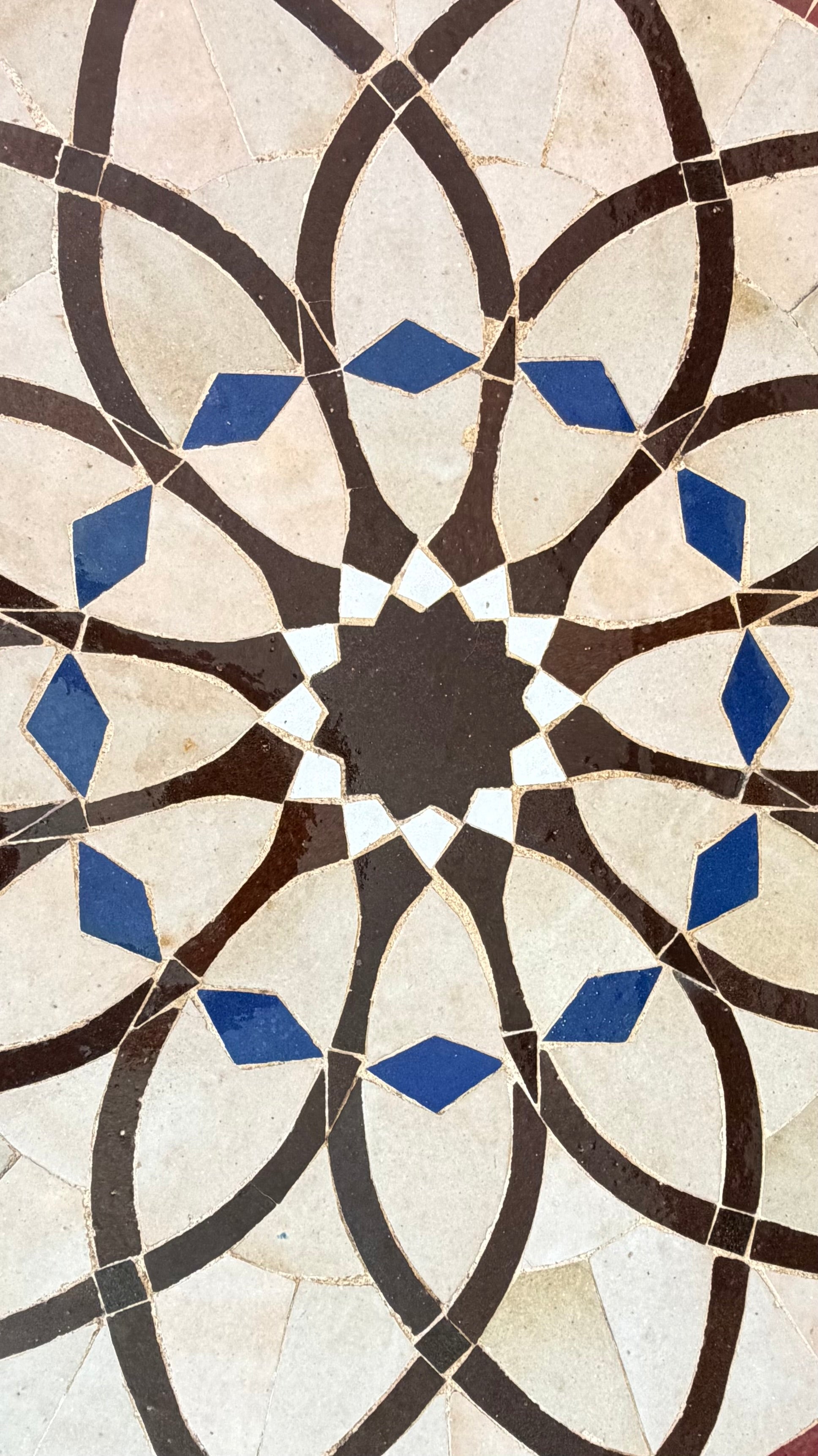 Moroccan Alhambra palace tile by Justmorocco featuring intricate blue and white geometric patterns in ceramic.