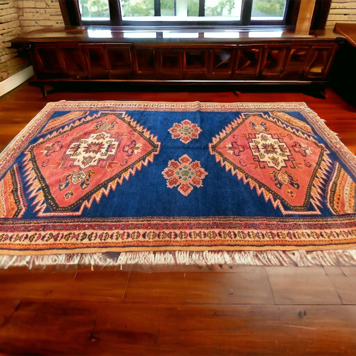Colorful Taznakht tribal rug from Justmorocco featuring traditional geometric patterns and vibrant earthy tones.