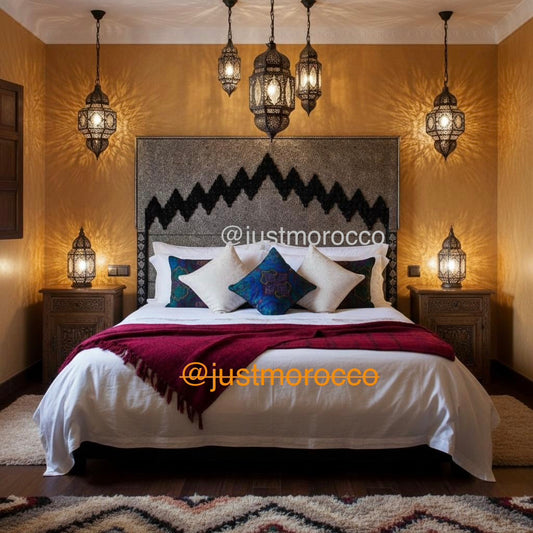Moroccan-style bedroom with patterned headboard and hanging lanterns, featuring 'justmorocco' branding.
