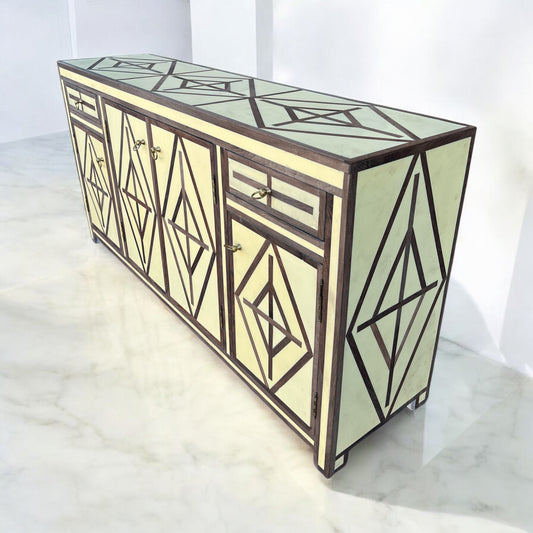A handmade Moroccan credenza with geometric inlaid wood and resin in white and black colors, featuring drawers and door panels.