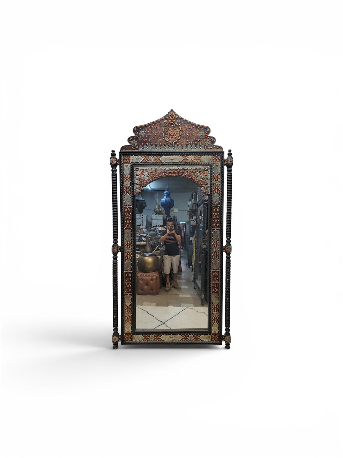 Decorative mirror with intricate design on a white background