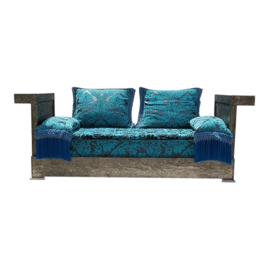 Teal patterned Moroccan sofa with wooden frame on a white background