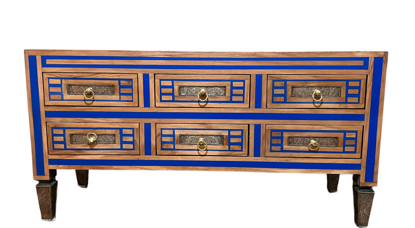 A Moroccan cabinet with blue and brown colors, featuring inlaid wood and resin design, with drawers and door panels.