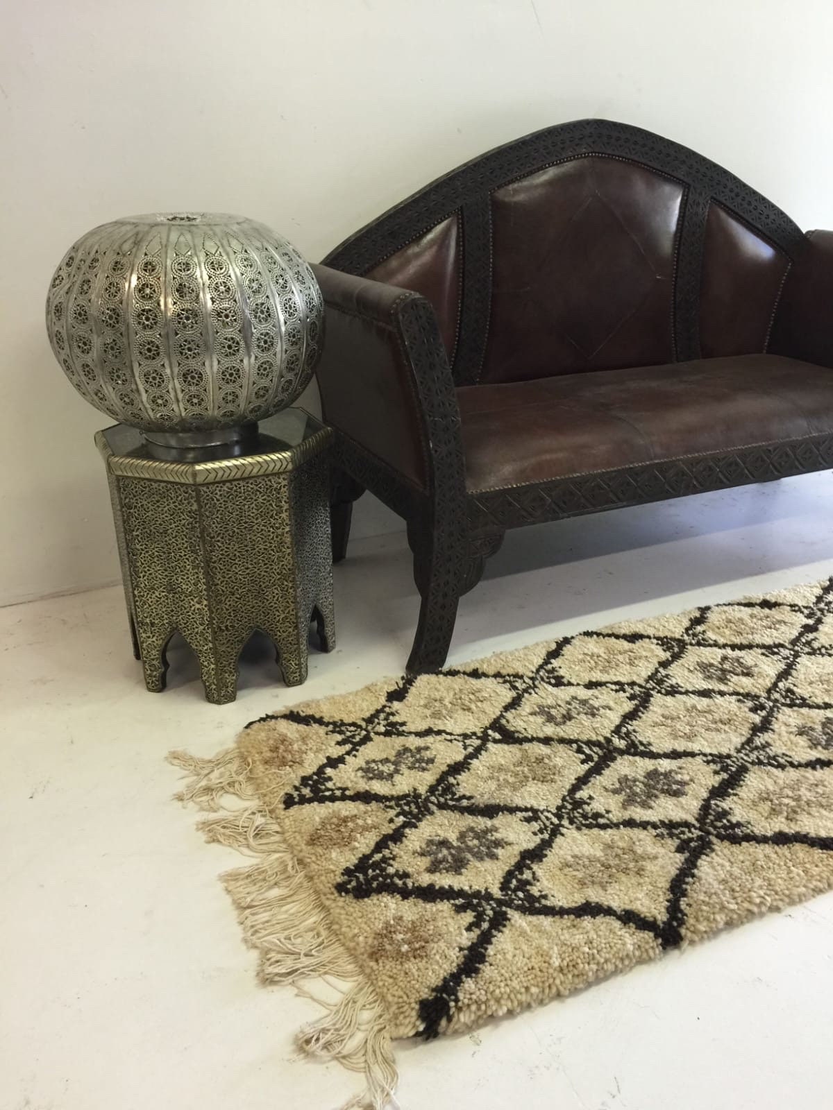 Beni ourain rug & Moroccan carved leather bench