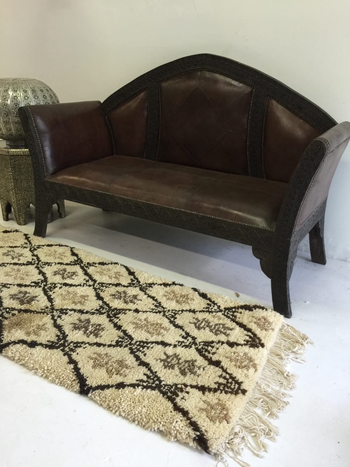 Beni ourain rug & Moroccan carved leather bench