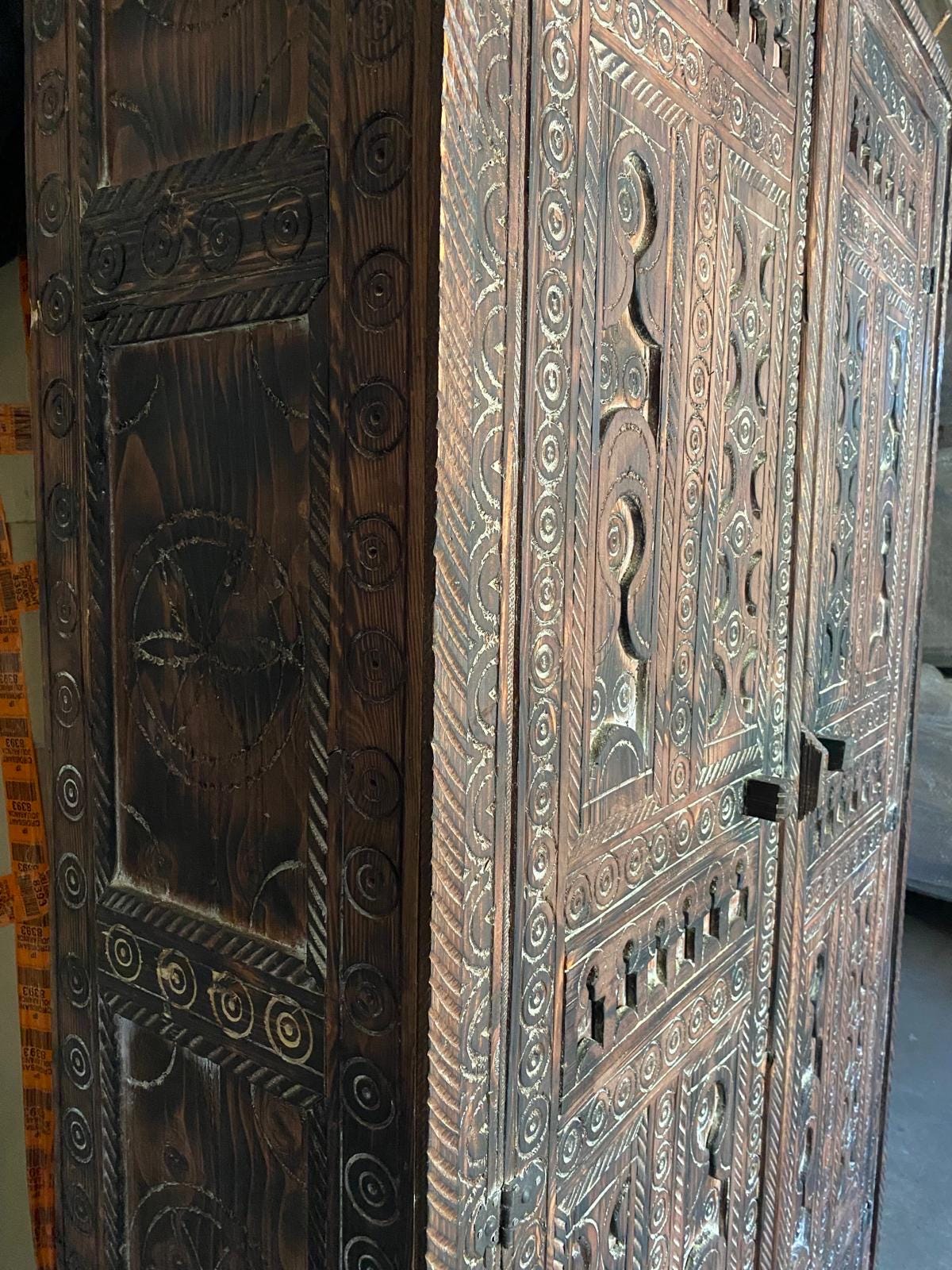 Handmade wooden Touareg African armoire with Moroccan tribal design, featuring intricate patterns and natural wood finish.