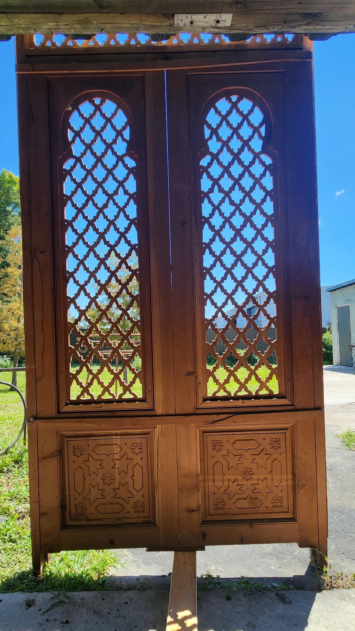 Old Moorish cedar wood door with fleur de lys panel carving, measuring 88 by 47 inches, from Justmorocco.