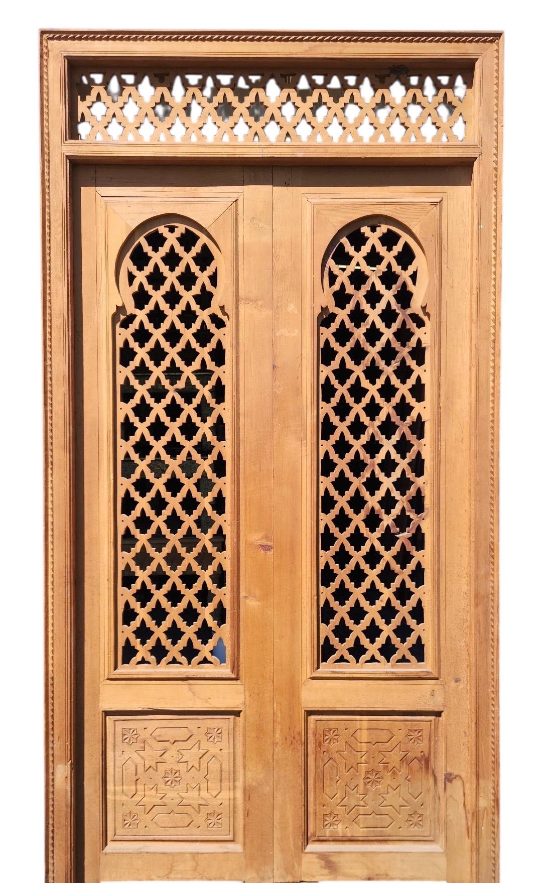 Old Moorish cedar wood door with Fleur de Lys carved panel, measuring 88 by 47 inches, from Justmorocco.